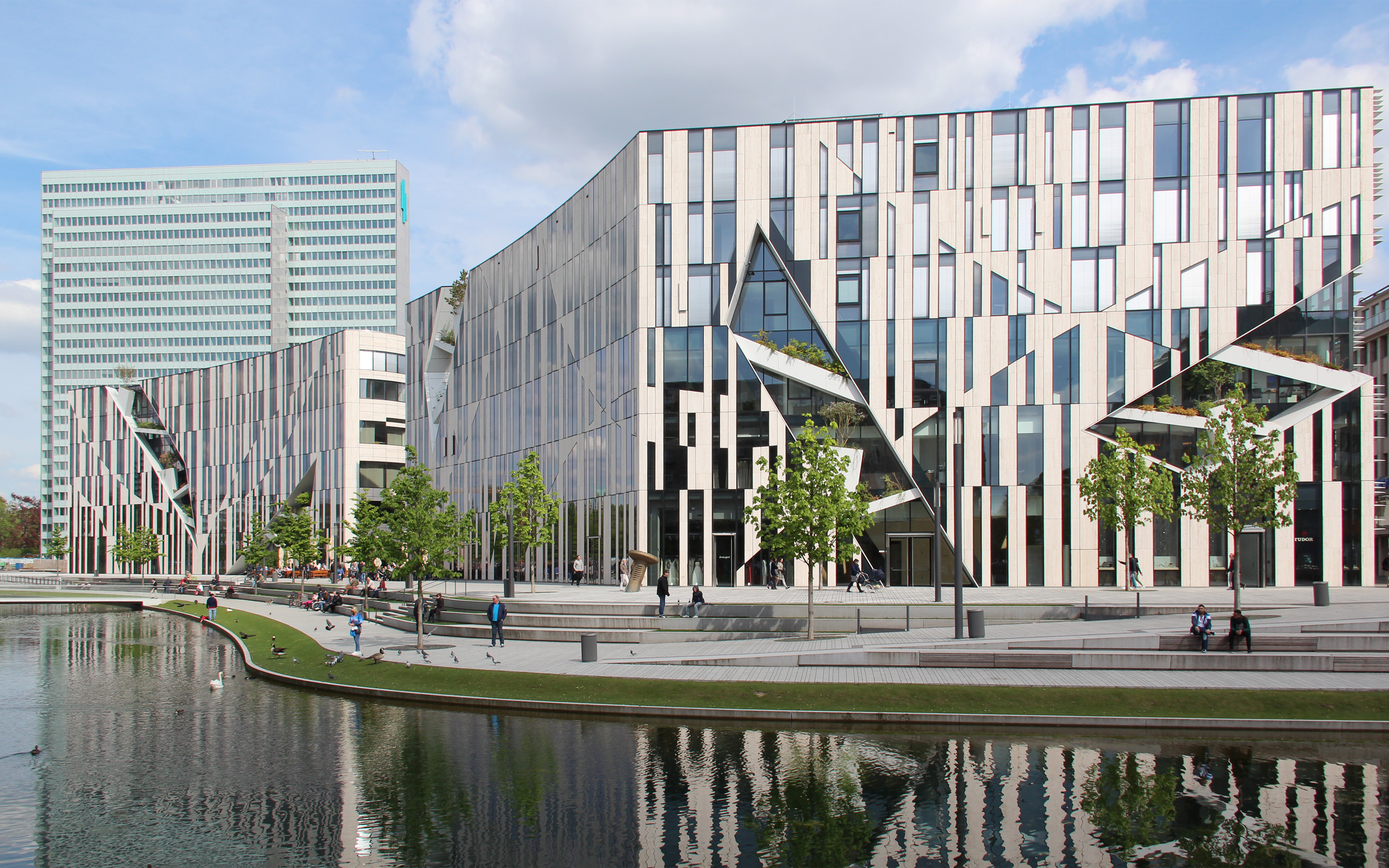 Large building with façade featuring natural stone and glass